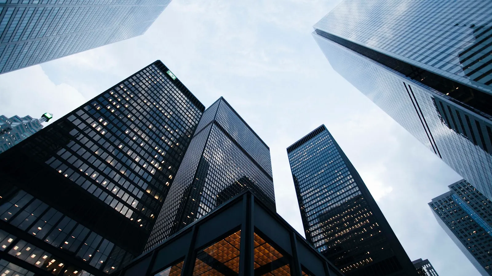 Glass office towers photographed looking upward