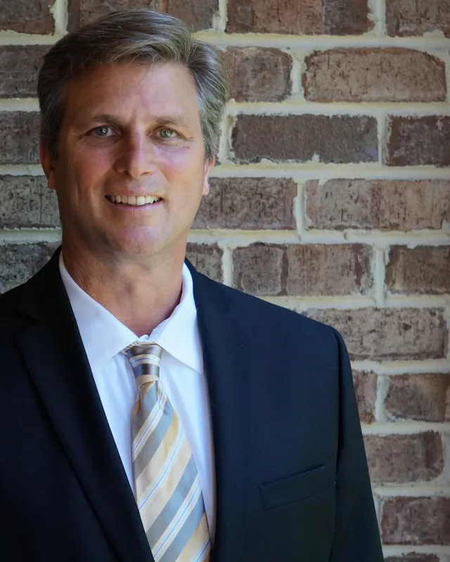 Portrait of a man in a suit and tie.