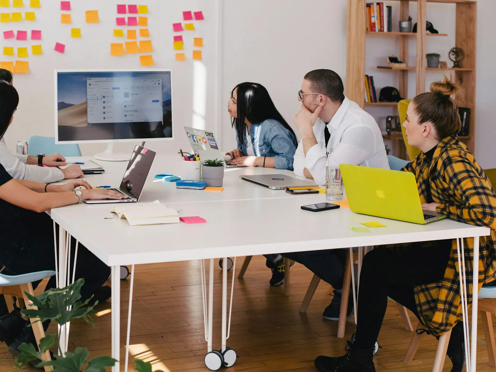A project team working through a plan together in a bright meeting room